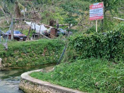 A warning sign erected by the Westmoreland Public Health Department at a stream in the parish. 