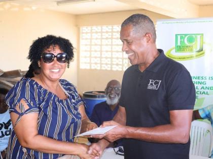 Factories Corporation of Jamaica Chairman Lyttleton ‘Tanny’ Shirley (right) presents to Dannette Vickers, a Westmoreland business owner during the handover ceremony on December 17.