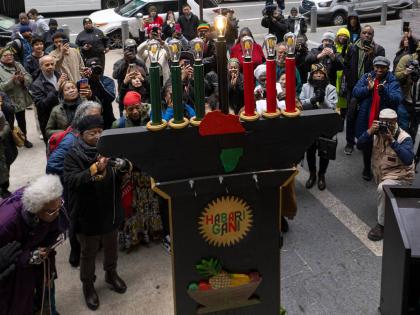 
Philadelphians and visitors gather during the the lighting of the city’s first kinara on the first day of Kwanzaa celebrations at the Philadelphia City Hall grounds on December 26, 2023.