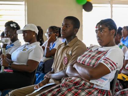 Students listen attentively during the launch of Miss St Thomas Festival Queen’s parish project.