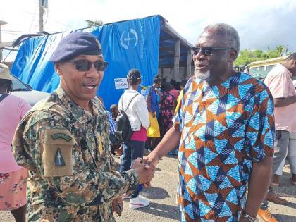 Brigadier Mahatma Williams, commander of the Second Battalion Jamaica Regiment, Jamaica Defence Force, exchanging pleasantries with Bishop Conrad H. Pitkin, custos of St. James, at the Brigade’s 2025 Children’s Christmas Fun Day held at the Maroon Town