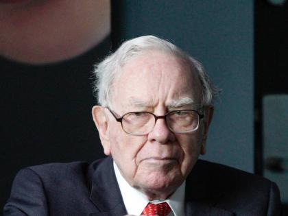 Warren Buffett, outgoing CEO of Berkshire Hathaway, opens a bottle of Cherry Coke during a game of bridge outside Berkshire-owned Borsheims jewellery store in Omaha, Nebraska, USA. 
