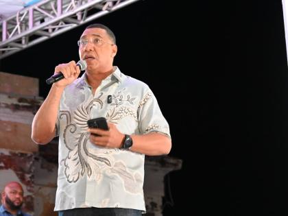 Prime Minister Dr Andrew Holness addressing residents of Black River and surrounding communities at the New Year’s fireworks show staged by the Urban Development Corporation on Thursday in the St Elizabeth capital.