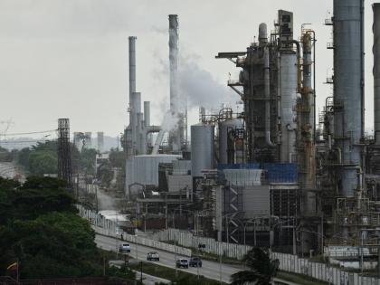 Vehicles drive past the El Palito refinery in Puerto Cabello, Venezuela, on December 21, 2025.