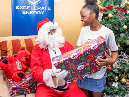Oneika Broomfield of Old Harbour Bay is thrilled to receive a gift from Santa during the toy donations held at the Old Harbour Bay Community Centre. 