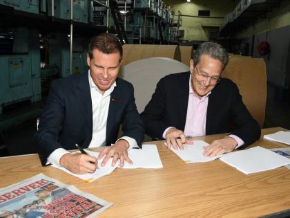 Executive Chairman of Jamaica Observer Limited Adam Stewart (left), and Executive Chairman of RJRGLEANER Communications Group Joseph Matalon sign the joint-venture agreement that set the foundation for the establishment of North Beech Limited – the new e