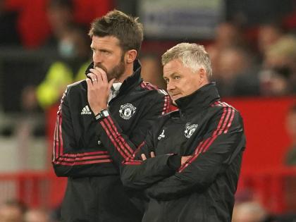Manchester United’s manager Ole Gunnar Solskjaer (right) and his assistant Michael Carrick stand on the touchline during an English League Cup football match against West Ham at Old Trafford in Manchester, England, on September 22, 2021.