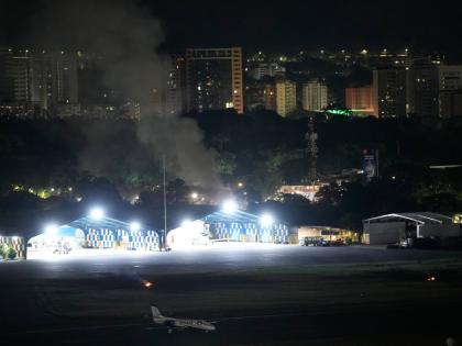 Smoke raises at La Carlota airport after explosions and low-flying aircraft were heard in Caracas, Venezuela.