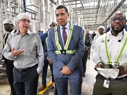 Sheldon Sharpe, (right) Business Unit Manager at Wisynco, and Andrew Mahfood, (left) CEO of Wisynco Group, explain how its new plant works to Prime Minister Dr Andrew Holness during at tour of the facility in Lakes Pen, St Catherine on Tuesday, January 13,