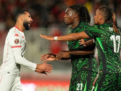 Tunisia’s Ali Abdi (left) argues with Nigeria’s Calvin Bassey and Alex Iwobi (right) during the Africa Cup of Nations group C football match in Fez, Morocco, on Saturday, December 27, 2025.