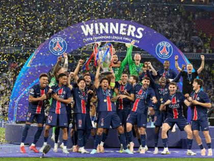 PSG’s Marquinhos holds up the trophy as he celebrates with his teammates after winning the Champions League final fooball match against Inter Milan at the Allianz Arena in Munich, Germany, on Saturday, May 31, 2025.