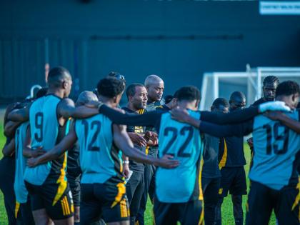 Reggae Boyz interim coach Rudolph Speid huddles with his charges during a training session at Sabina Park.