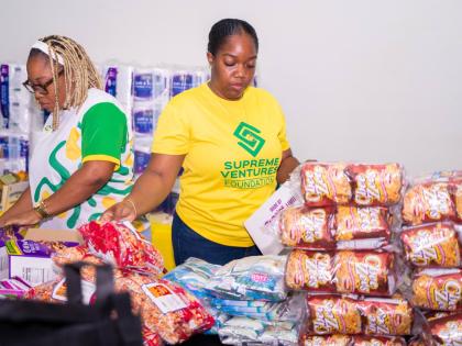 Supreme Ventures team members pack care packages. 