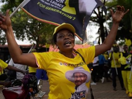 A woman celebrates President Yoweri Museveni’s victory in the presidential election in Kampala, Uganda.