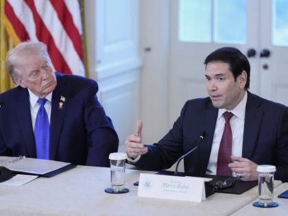President Donald Trump listens to Secretary of State Marco Rubio speak during a meeting with oil executives in the East Room of the White House.