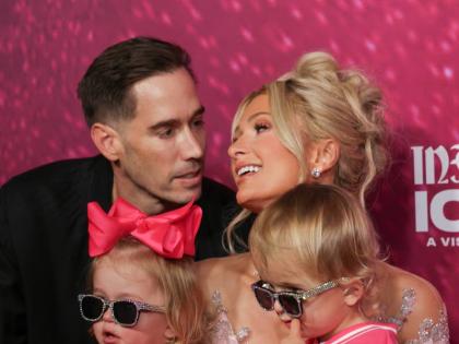 Joined by her husband, Carter Reum, and their two children, Phoenix (right) and London (second left), Hilton celebrated the evening with them in coordinating outfits featuring, of course, pops of pink.