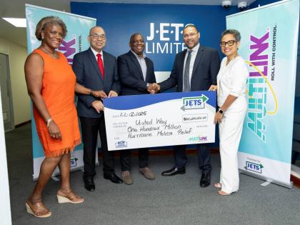 Chair of the Board of Directors for United Way of Jamaica Dr Devon Smith (centre) accepts the cheque for $100 million from J.E.T.S Limited CEO Edmundo Jenez (second right). Also at the handover are: (from left) Strategic Marketing Consultant to JETS Ltd, M