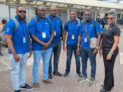 A crew of linemen from Barbados pause for a moment, shortly after arrival in the island to assist with electricity restoration.