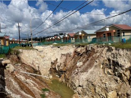 The deep pit initially caused by land caving in at The Estuary housing scheme, in St James.