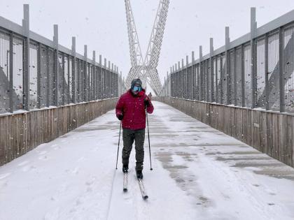 Jacob Coleman skis across SkyDance Bridge over Interstate 40 during a snowstorm in Oklahoma City on January 24, 2026.