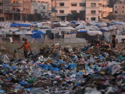AP 
Children sort through trash at a landfill in al-Bureij camp, in the central Gaza Strip.