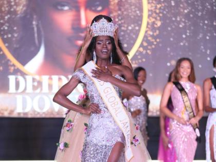 An overwhelmed Deidrian Downer is crowned Miss Global Jamaica 2026 by Keri-Ann Greenwood, Miss Global Jamaica 2025 and first Runner-up Miss Global 2025 during the Grand Coronation on Saturday  at the Douglas Orane Auditorium, Wolmer’s Boys, Kingston