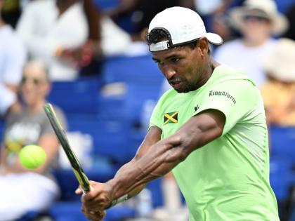 Jamaica’s Rowland Phillips plays a backhanded return during Davis Cup Group II action at the Eric Bell Tennis Centre in 2024.