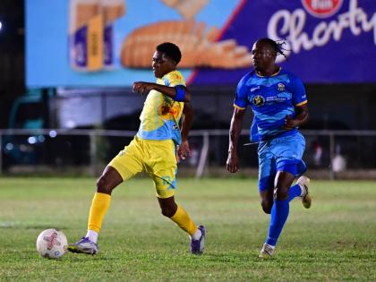 Ky-mani Campbell of Waterhouse FC (left) dribbles down field, chased by Tyrique Wilson of Molynes United FC during their Jamaica Premier League match at Waterhouse Mini Stadium on Sunday, December 28, 2025.
