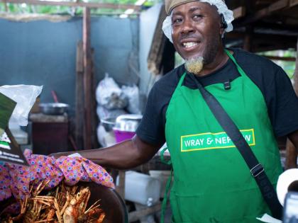 Popular vendor Coolie Man displays his much-talked-about French-fried lobster. 