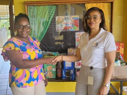  Kareen Dennis (right), secretary of the JN Circle Linstead Chapter, presents breakfast supplies to Annette Steele, principal of Victoria Primary School.