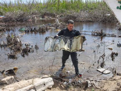 Matthew Samuda, minister of water, environment and climate change removes debris from a mangrove ecosystem in Parottee, St. Elizabeth, during clean-up activity marking World Wetlands Day on February 2. 