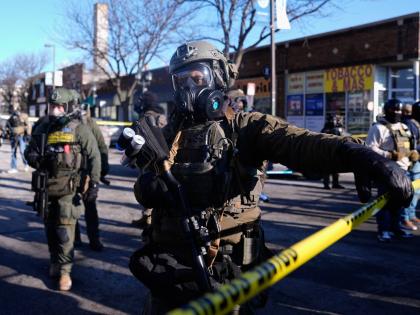 Federal agents stand near the site of a shooting in Minneapolis.