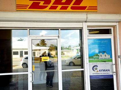 DHL signage displayed above the entrance to the Premier Branch at JN Money Eastern Avenue, Grand Cayman.