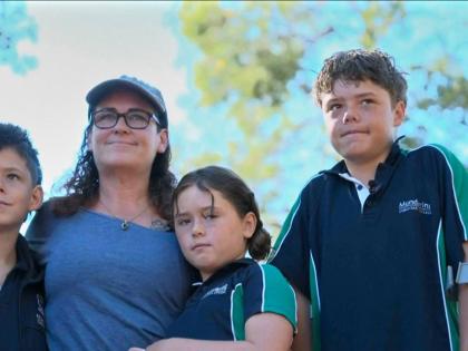 This image taken from video shows Austin Appelbee, right, posing with his family in Gidgegannup, Australia, Tuesday February 3, 2026. (ABC via AP)