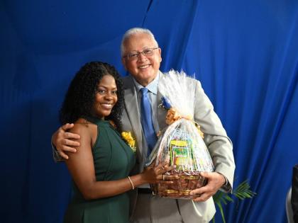 Minister of Justice Delroy Chuck accepts a gift from a newly commissioned Justice of the Peace, Noelle  StacyAnn Randall, following his keynote address at the JP commissioning ceremony at The Commingle Hotel in Westmoreland.