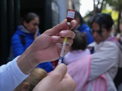 A health worker administers a dose of the measles vaccine outside a public hospital in Mexico City on February 4, 2026. 