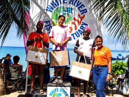 Excitement overflowed in the water, along the shoreline,  and at the winner’s podium as teenage female participants in Swim for the Sanctuary kept Tazhna Williams (right), public relations & corporate events executive at Massy Distribution Jamaica Limit