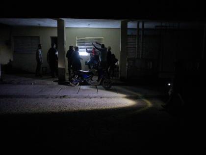 People celebrate a birthday during a scheduled power outage in Santa Cruz del Norte, home to one of Cuba’s largest thermoelectric plants.