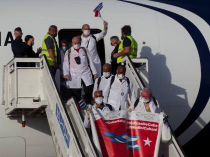Cuban doctors arrive at the Jose Marti International Airport in Havana, Cuba, June 8, 2020, after travelling to Italy to help with the COVID-19 emergency response. (Ismael Francisco/Pool via AP, File)