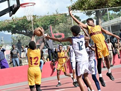 ISSA Under-16 Basketball final action between Wolmer’s Boys’ School and Jamaica College at Campion College yesterday.