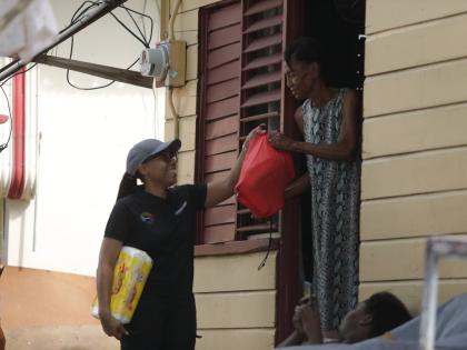  Imega Breese McNab (centre), corporate affairs manager and company secretary at Carreras, joined the team in providing emergency relief supplies to residents in Savanna-La-Mar, Westmoreland in the immediate aftermath of Hurricane Melissa.