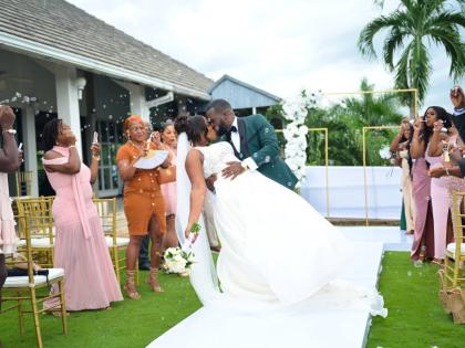 A playful dip and a sweet kiss sealed the moment for the newly-weds, marking the start of their life together as husband and wife.
