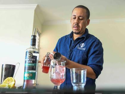 Hudson’s Cocktail Story’s Wynton Hudson pours his watermelon cucumber cordial into a goblet.