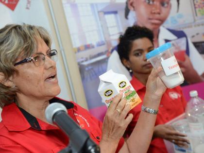 Deborah Chen (left), executive director of Heart Foundation of Jamaica, shows an example of a box drink and the equivalent sugar content, while Ponetta Nurse, advocacy officer of HFJ, looks on.