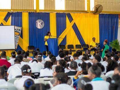 An executive member of the Kiwanis Club of Linstead addresses students at the college fair. 