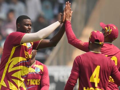 West Indies’ Jason Holder (left) celebrates with teammates after dismissing Nepal’s Aarif Sheikh during the T20 World Cup cricket match against Nepal in Mumbai, India, on February 15.
