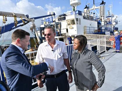 Daryl Vaz (centre), minister of science, energy, telecommunications and transport, and Kedesha Campbell Rochester (right), permanent secretary, chat with Brian Larken, CEO, United Oil & Gas, during a vessel tour of the ‘R/V Gyre’ as part of United Oil 