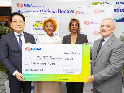 Charmaine Heslop-DaCosta (second right), senior vice president, People Operations, Jamaica Public Service (JPS), and Sophia Lewis (second left), Head, JPS Foundation, stand with Myung Ho Kwon (left), chief executive officer, EWP, and Damian Obiglio (right)