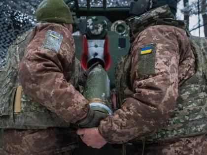Ukrainian servicemen load an artillery shell before firing at Russian positions on the front line in Kharkiv region of Ukraine, Wednesday, February 18, 2026. (AP Photo/Andrii Marienko, File)