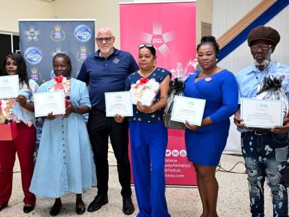 (From left) Kemecia Chambers, Andrea Archibald, Diane McClune, Latoya Coleman-Morgan and Derrick Johnson are presented with certificates and gift baskets courtesy of Scotiabank and Carreras, honouring their outstanding service and leadership in the May Pen